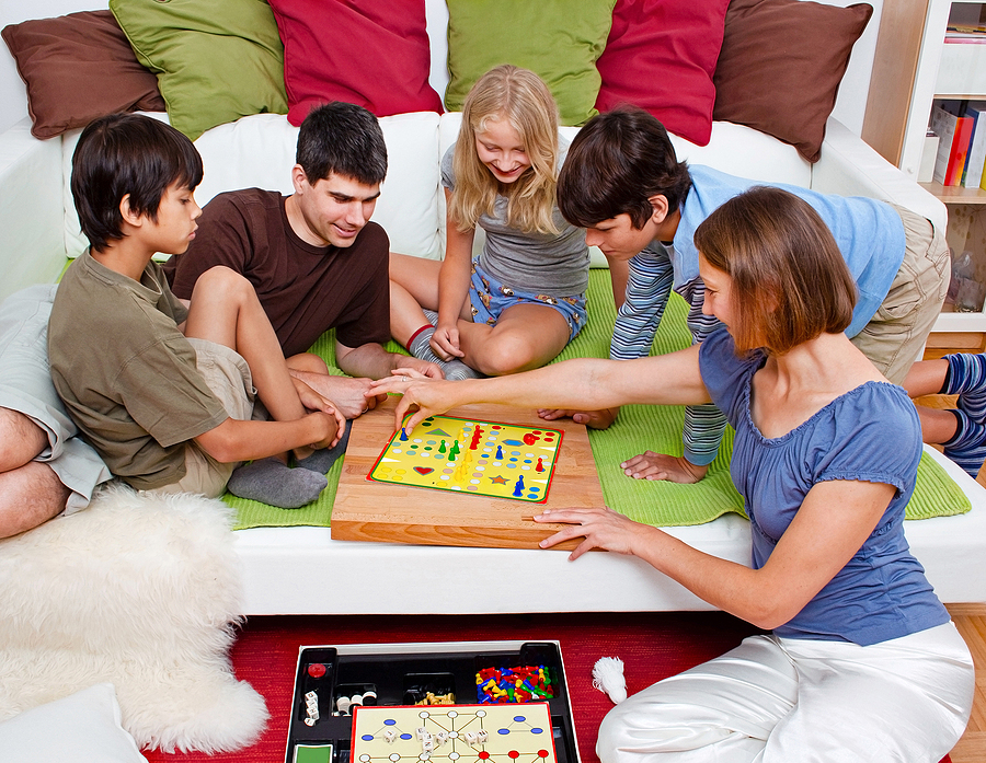 Setting Attainable Goals for 2022. Family Playing Board Game